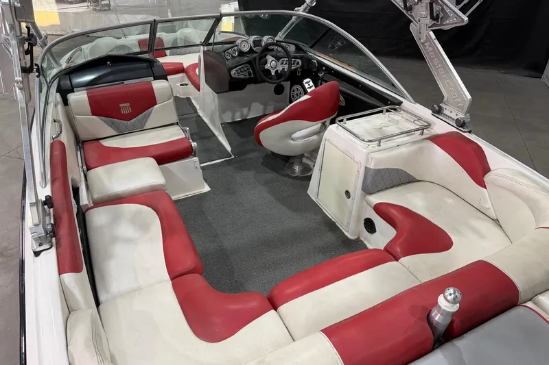 Slide: The Image of 2008 MasterCraft X-35 boat interior with red and white seating, dashboard, and steering wheel. - 7