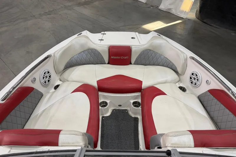 Slide: The Image of 2008 MasterCraft X-35 boat interior with red and white seating, diamond-pattern accents. - 9