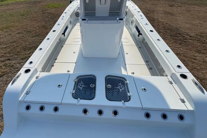 Slide: The Image of 2023 Freeman 28 boat deck with storage compartments and rod holders. - 11
