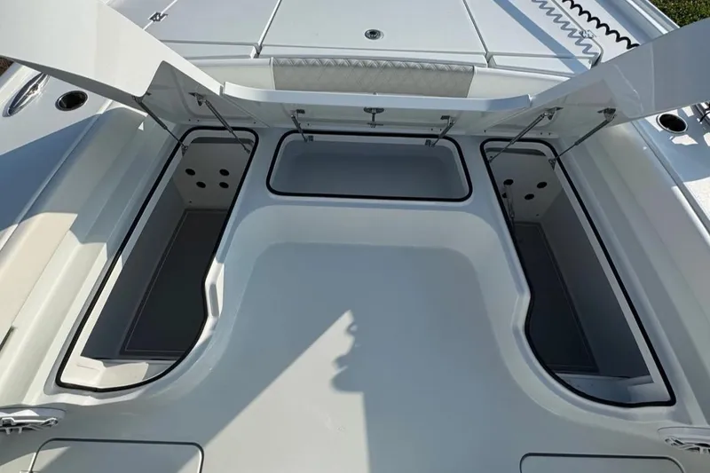 Slide: The Image of Open storage compartments on a 2023 Freeman 28 boat deck. - 13