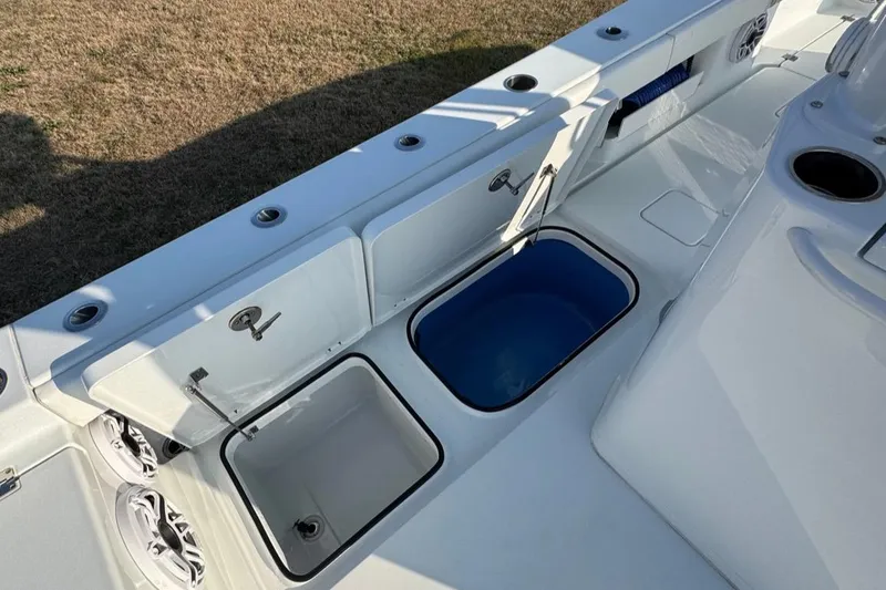 Slide: The Image of 2023 Freeman 28 boat deck with open storage compartments and cup holder. - 14