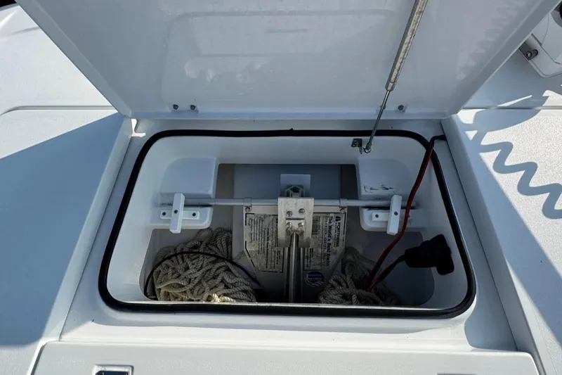 Slide: The Image of Open storage compartment on a 2023 Freeman 28 boat, containing ropes and equipment. - 15