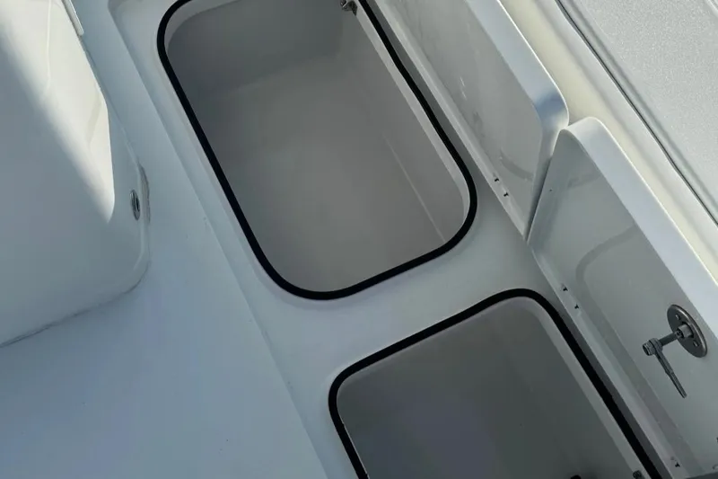 Slide: The Image of Open storage compartments on a 2023 Freeman 28 boat deck. - 17
