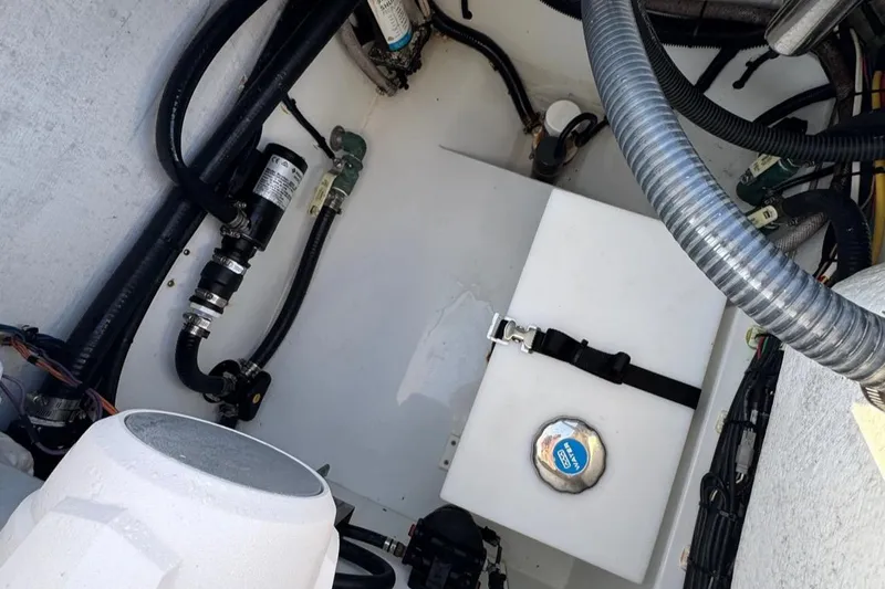 Slide: The Image of Engine compartment of a 2023 Freeman 28 boat, featuring hoses and mechanical components. - 18