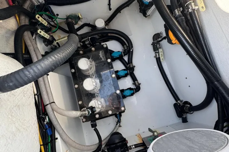 Slide: The Image of Engine compartment of a 2023 Freeman 28 boat, showcasing wiring and components. - 19