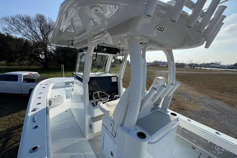 Slide: The Image of 2023 Freeman 28 boat with modern helm, parked near a white truck. - 4