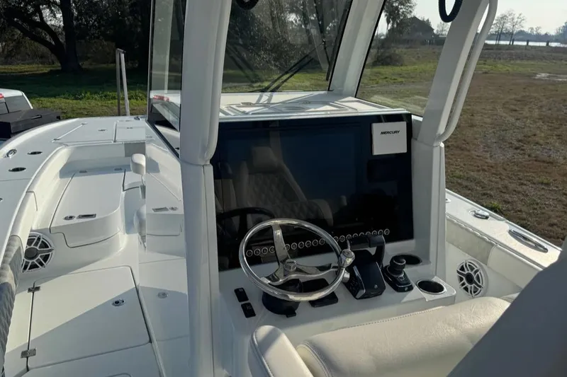 Slide: The Image of 2023 Freeman 28 boat cockpit with steering wheel and control panel. - 5