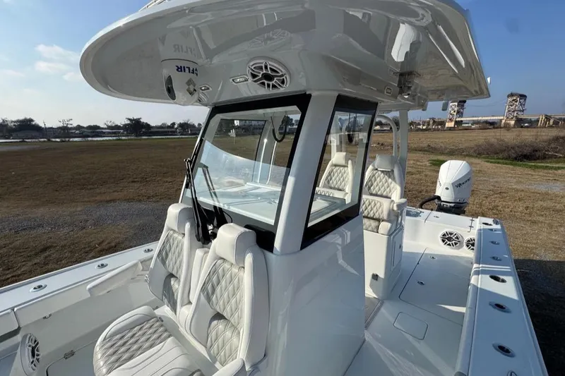 Slide: The Image of 2023 Freeman 28 boat with luxurious seating and modern design on display outdoors. - 6