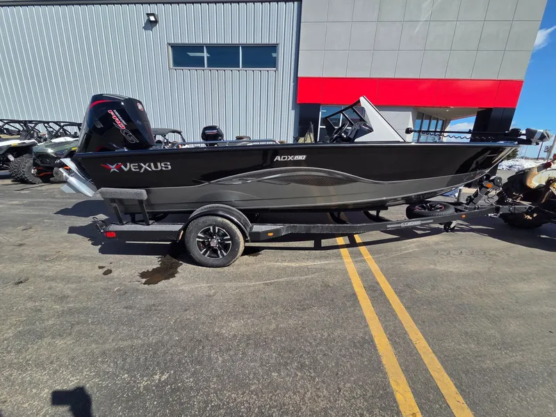 Slide: The Image of 2026 Vexus Boats ADX190 on trailer in front of building. - 2