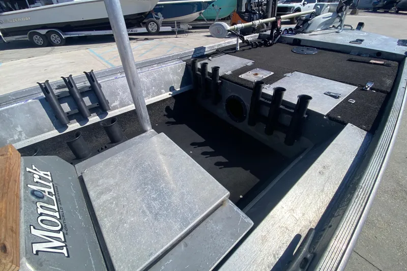 Slide: The Image of 1979 Monark 1648 Jon boat interior with rod holders and storage compartments. - 11