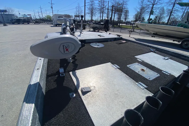 Slide: The Image of 1979 Monark 1648 Jon boat deck with trolling motor in a sunny outdoor setting. - 20