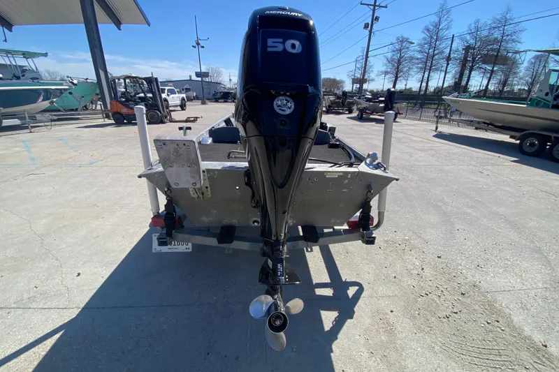Slide: The Image of 1979 Monark 1648 Jon boat with Mercury 50 outboard motor in a marina setting. - 4