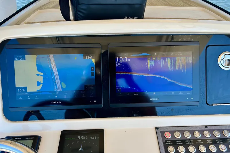 Slide: The Image of Dashboard of 2024 Scout 277 LXF boat with Garmin navigation displays. - 11