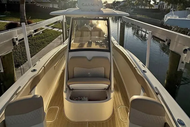 Slide: The Image of 2024 Scout 277 LXF boat docked, featuring sleek design and modern amenities. - 18