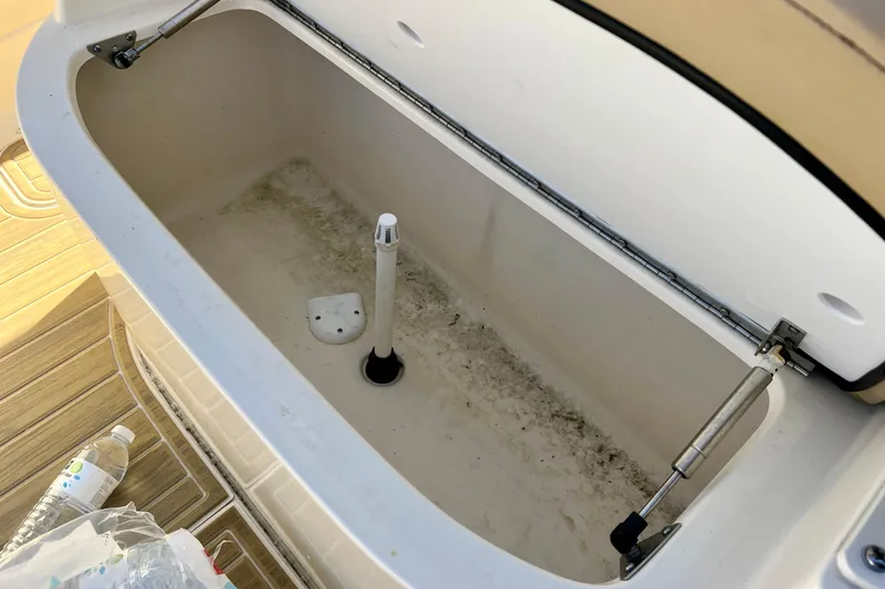 Slide: The Image of Open storage compartment on 2024 Scout 277 LXF boat, showing interior details. - 21
