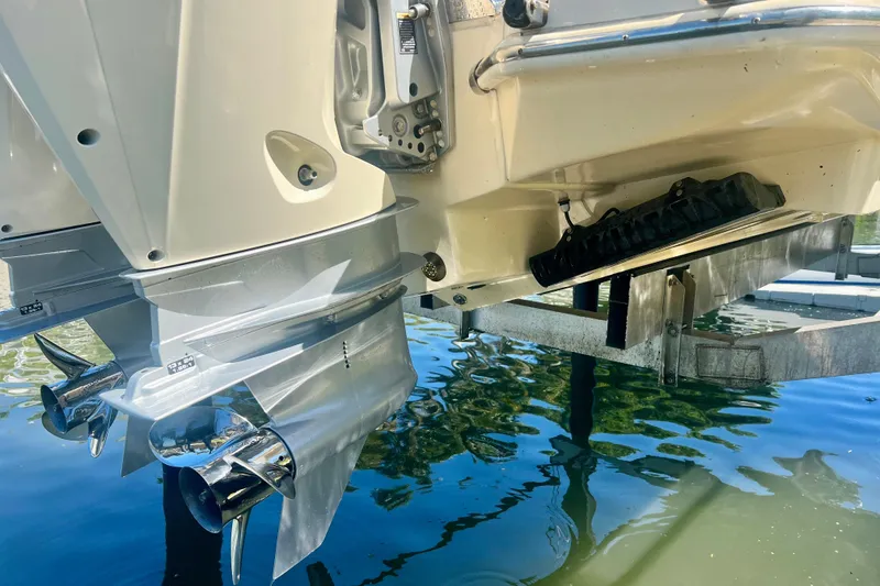 Slide: The Image of 2024 Scout 277 LXF boat with dual outboard motors on a lift. - 22