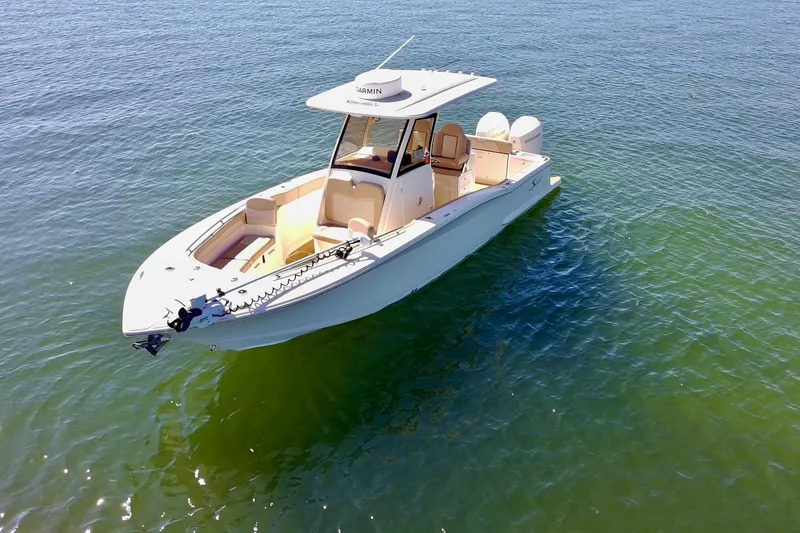 Slide: The Image of 2024 Scout 277 LXF boat on calm water, showcasing sleek design and modern features. - 4