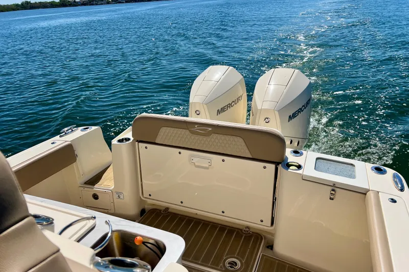 Slide: The Image of 2024 Scout 277 LXF boat with dual Mercury engines on open water. - 7