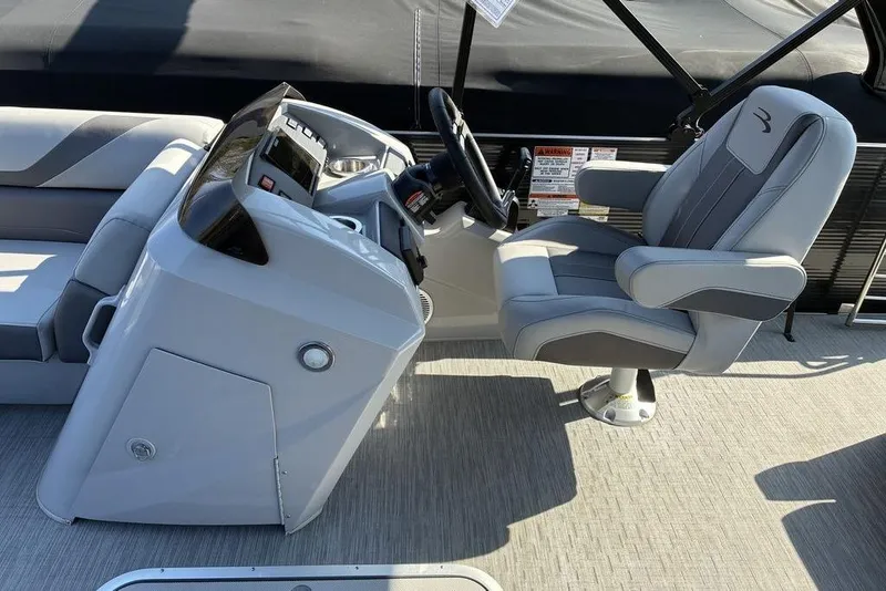 Slide: The Image of Captain's seat and helm of a 2022 Bennington 22 SSBX pontoon boat. - 7
