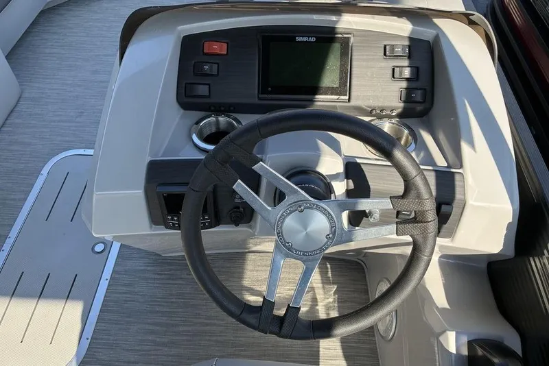 Slide: The Image of Steering console of 2022 Bennington 22 SSBX boat with Simrad display and controls. - 8