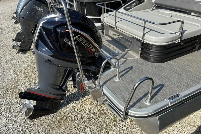 Slide: The Image of 2022 Bennington 22 SSBX pontoon boat with Yamaha outboard motor, docked on gravel. - 9