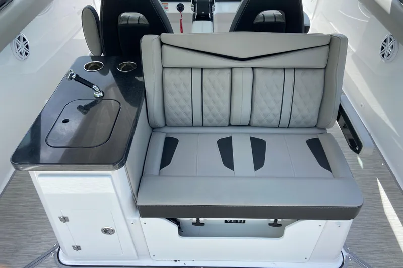 Slide: The Image of Luxurious seating and kitchenette on 2026 Monterey Elite 30 OB boat. - 11