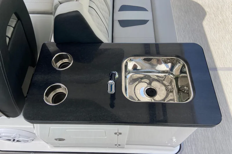 Slide: The Image of Luxury boat interior with sleek sink and cup holders on Monterey Elite 30 OB, 2026 model. - 14