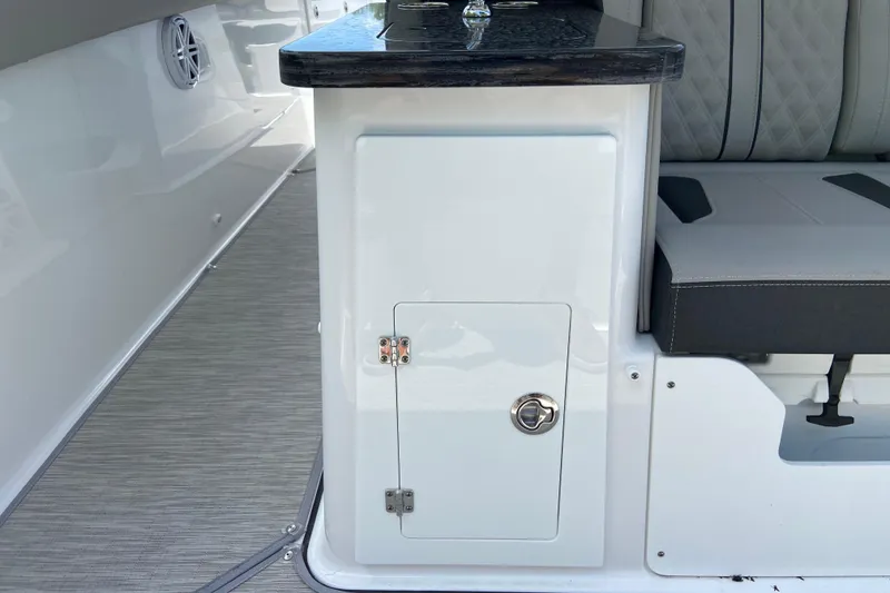 Slide: The Image of 2026 Monterey Elite 30 OB boat interior with sleek seating and storage compartment. - 15