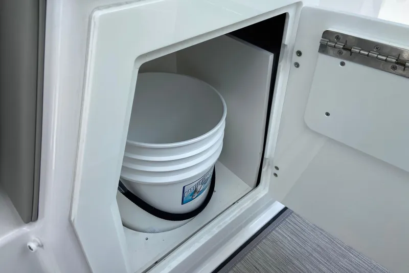 Slide: The Image of Storage compartment with bucket on 2026 Monterey Elite 30 OB boat. - 18