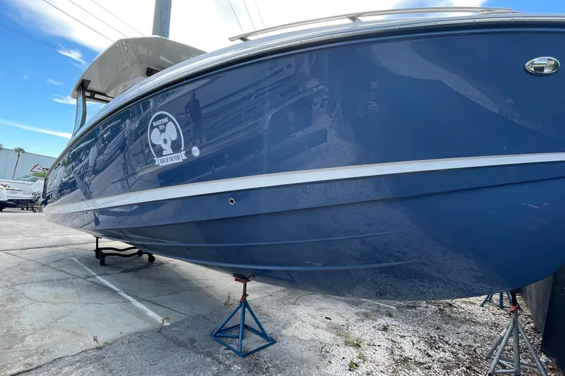 Slide: The Image of 2026 Monterey 30 ELITE boat in blue, displayed on stands outdoors. - 22