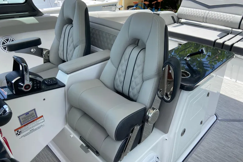 Slide: The Image of Luxury seating in 2026 Monterey Elite 30 OB boat cockpit, featuring modern controls and design. - 23