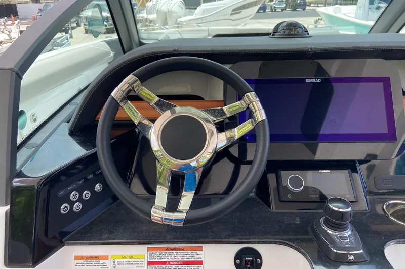 Slide: The Image of Steering console of 2026 Monterey Elite 30 OB boat with modern controls and display. - 25