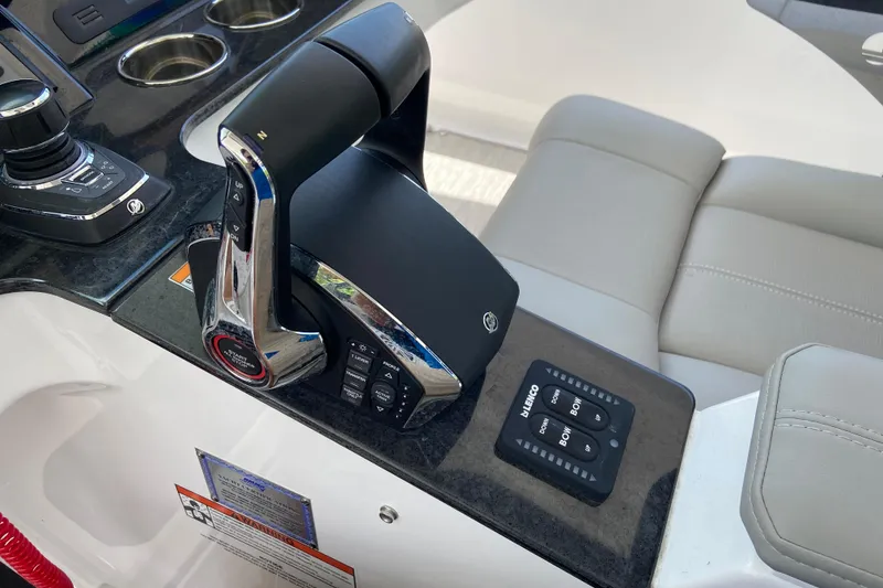 Slide: The Image of Control panel of 2026 Monterey Elite 30 OB boat with throttle and joystick. - 27