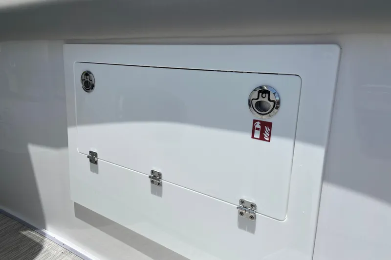 Slide: The Image of Hatch on 2026 Monterey Elite 30 OB boat with fire extinguisher symbol. - 29