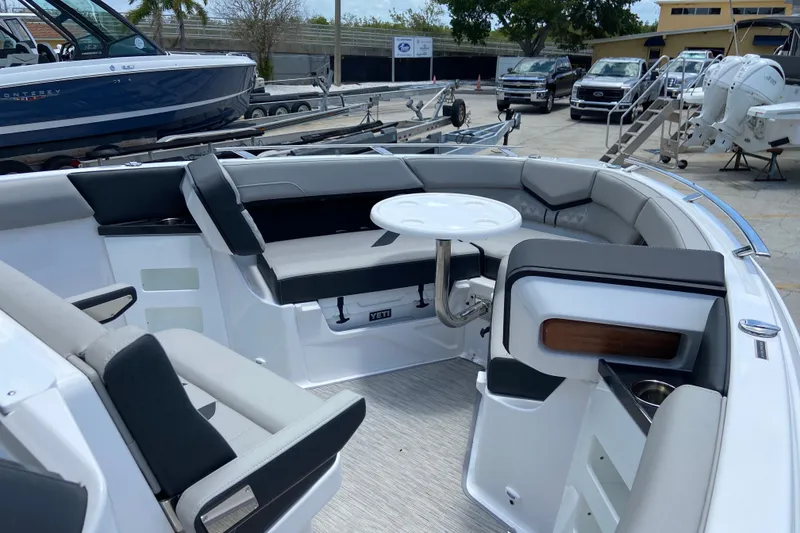 Slide: The Image of Interior of 2026 Monterey Elite 30 OB boat with seating and table. - 31