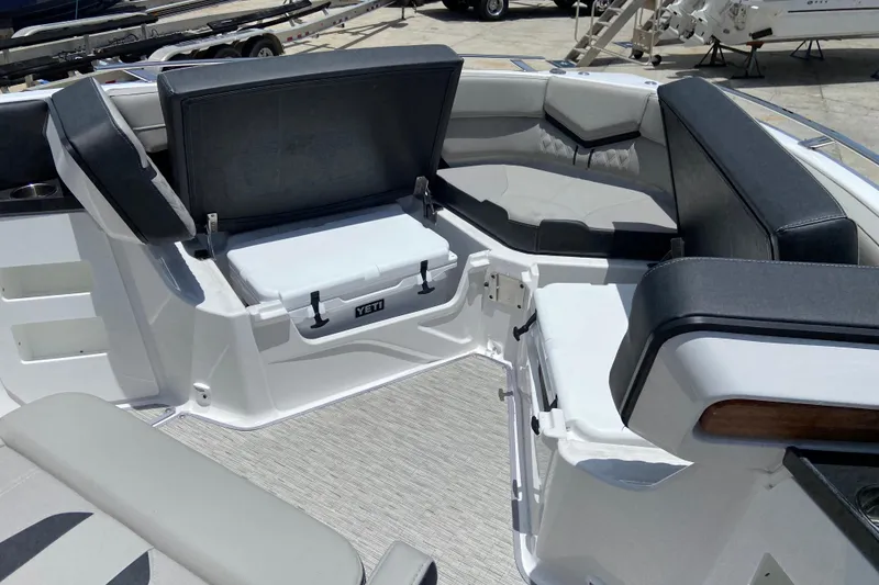 Slide: The Image of Interior of 2026 Monterey Elite 30 OB boat with seating and Yeti cooler. - 33
