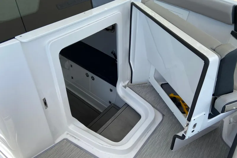 Slide: The Image of Interior view of 2026 Monterey Elite 30 OB boat, featuring open hatch and seating area. - 42