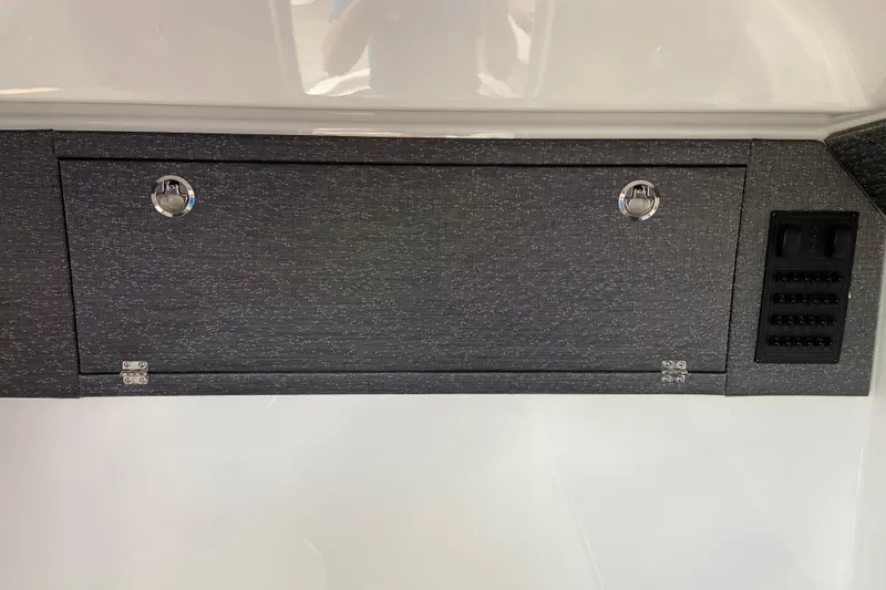 Slide: The Image of Control panel and storage compartment on 2026 Monterey Elite 30 OB boat interior. - 47