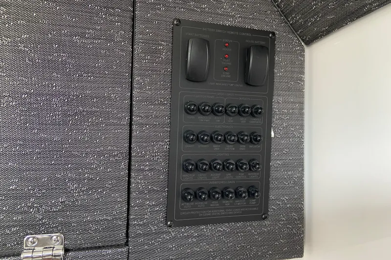 Slide: The Image of Control panel of a 2026 Monterey Elite 30 OB boat, featuring switches and indicators. - 48