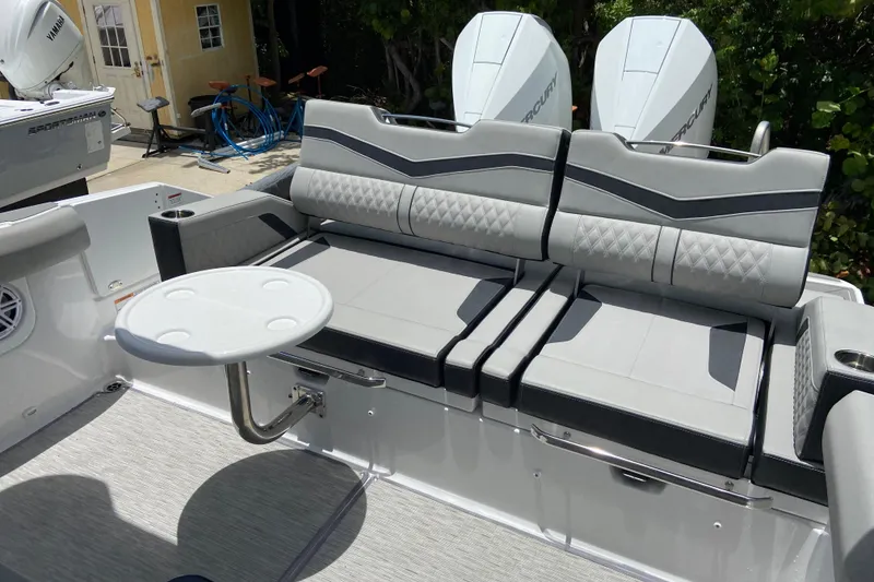 Slide: The Image of 2026 Monterey Elite 30 OB boat interior with gray seating and round table. - 6