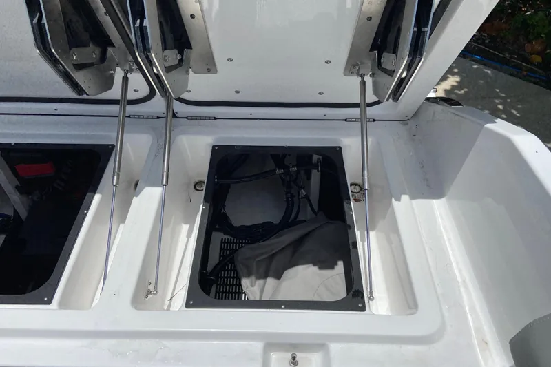 Slide: The Image of Open storage compartments on a 2026 Monterey Elite 30 OB boat. - 9