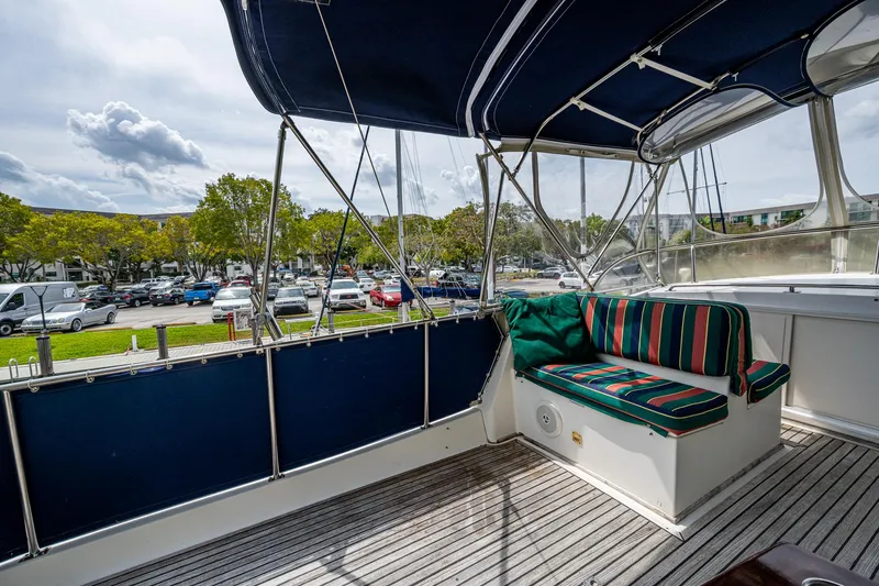 Slide: The Image of Covered deck area of a 1990 Grand Banks 46 Classic yacht with striped seating. - 19