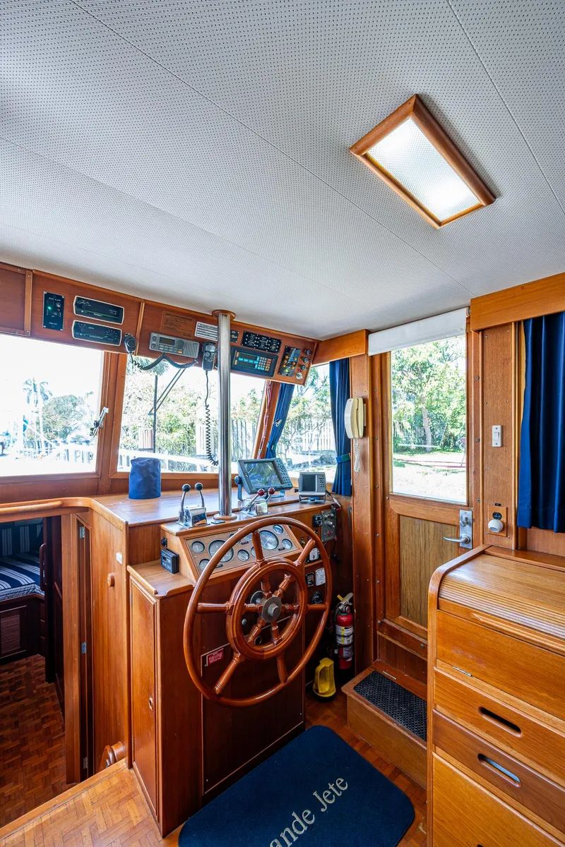 Slide: The Image of 1990 Grand Banks 46 Classic yacht interior with wooden helm and navigation equipment. - 27