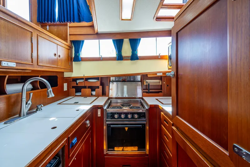 Slide: The Image of Interior of 1990 Grand Banks 46 Classic yacht kitchen with wood cabinetry and modern appliances. - 30