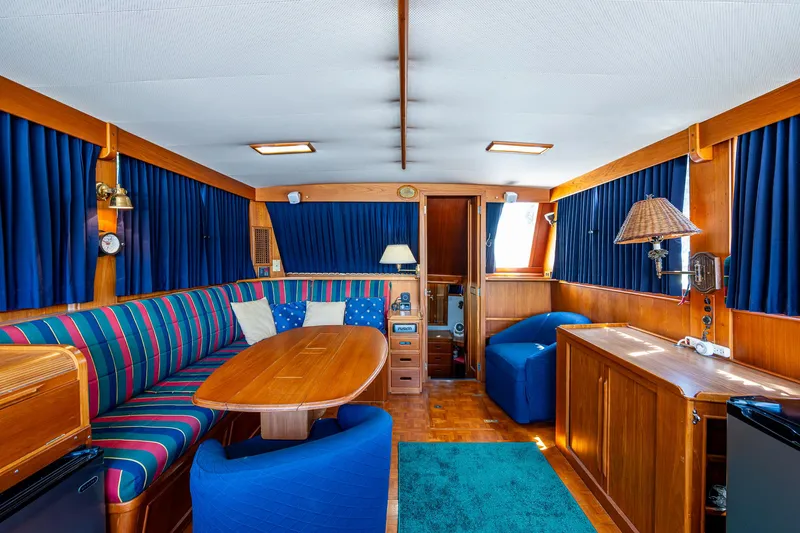 Slide: The Image of Interior of 1990 Grand Banks 46 Classic yacht with wood finish and blue accents. - 4