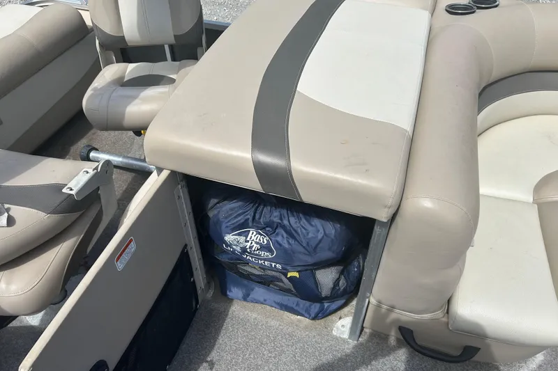 Slide: The Image of Sun Tracker Party Barge 22 Tritoon 2015 interior with storage compartment and life jackets. - 13