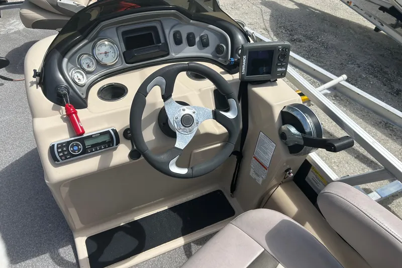Slide: The Image of 2015 Sun Tracker Party Barge 22 Tritoon dashboard with steering wheel and controls. - 15