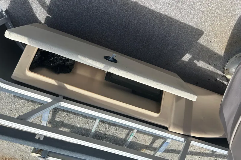 Slide: The Image of Open storage compartment on 2015 Sun Tracker Party Barge 22 Tritoon boat. - 16