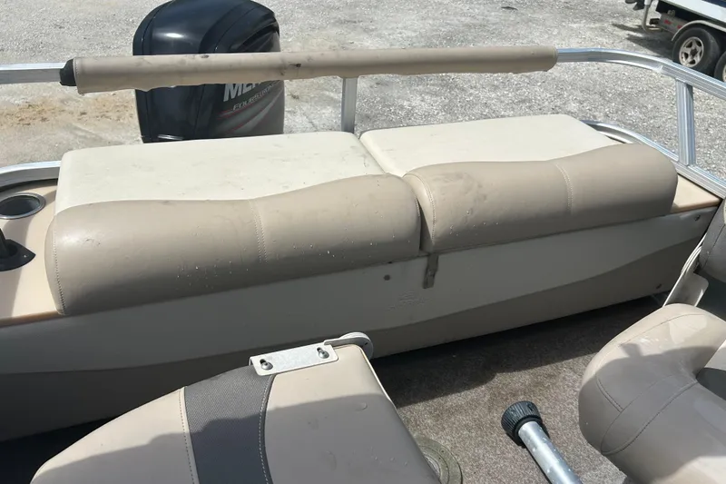 Slide: The Image of 2015 Sun Tracker Party Barge 22 Tritoon interior with beige seating and Mercury outboard motor. - 17