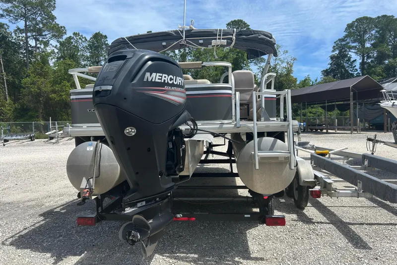 Slide: The Image of 2015 Sun Tracker Party Barge 22 Tritoon with Mercury outboard motor, parked on trailer. - 4